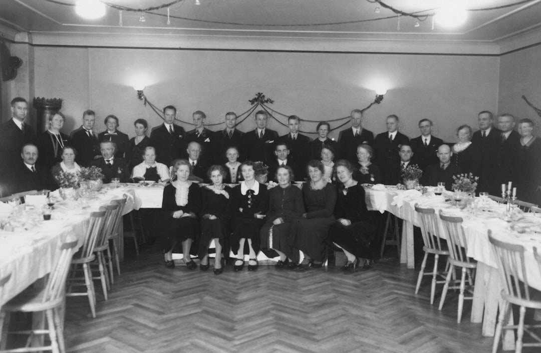 Group portrait of senior club members and volunteers standing together indoors