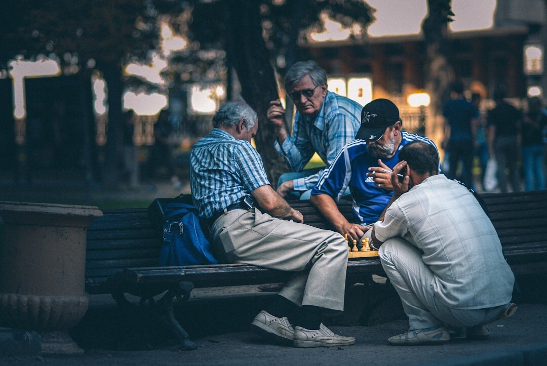 Group of happy senior friends laughing together outdoors in a park